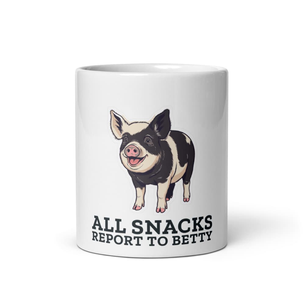 Ceramic mug printed with cartoon Betty the pig and the words all snacks report to Betty.