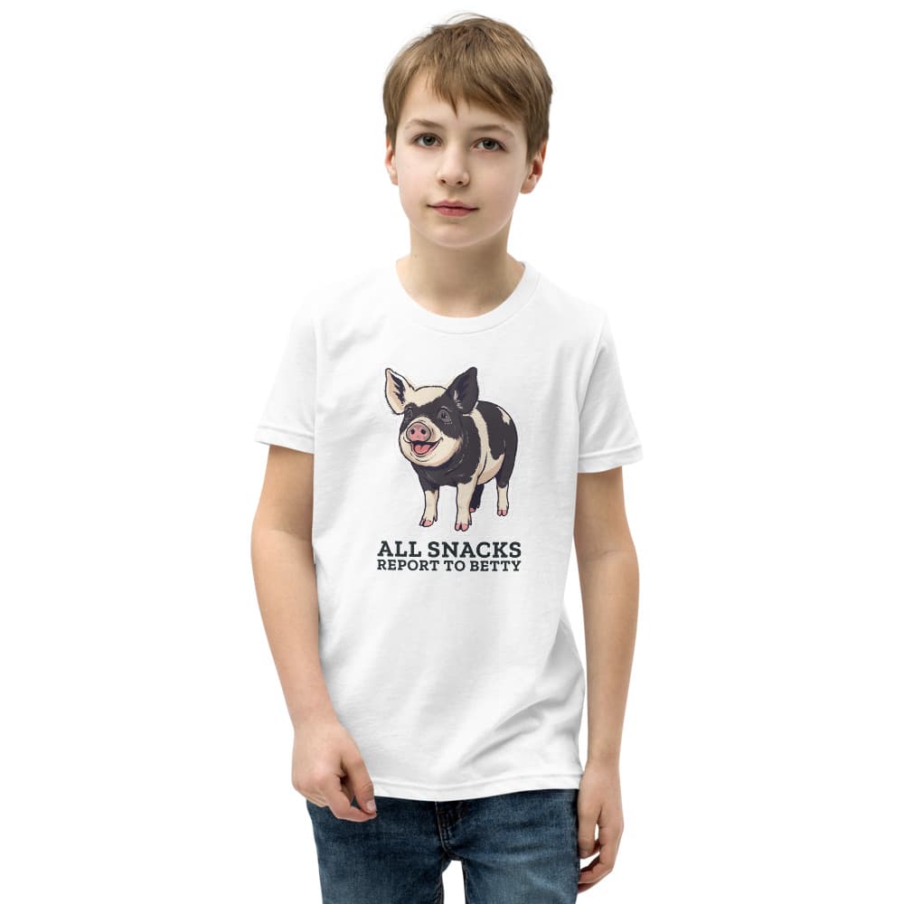 Kids t-shirt with a cartoon of Betty the black-and-cream pig above the words All Snacks Report to Betty. Shown in White.