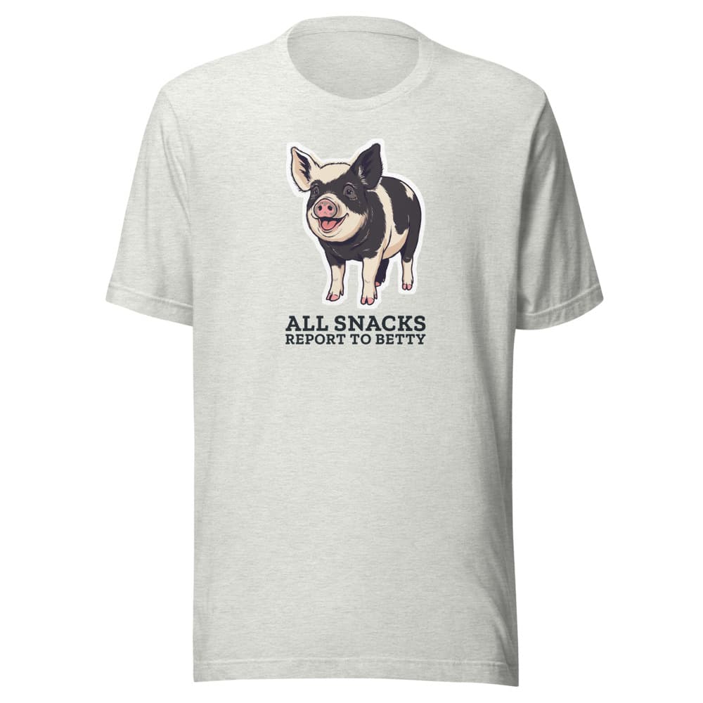 Light-colored t-shirt printed with cartoon Betty the pig and the words all snacks report to Betty. Shown in Ash.