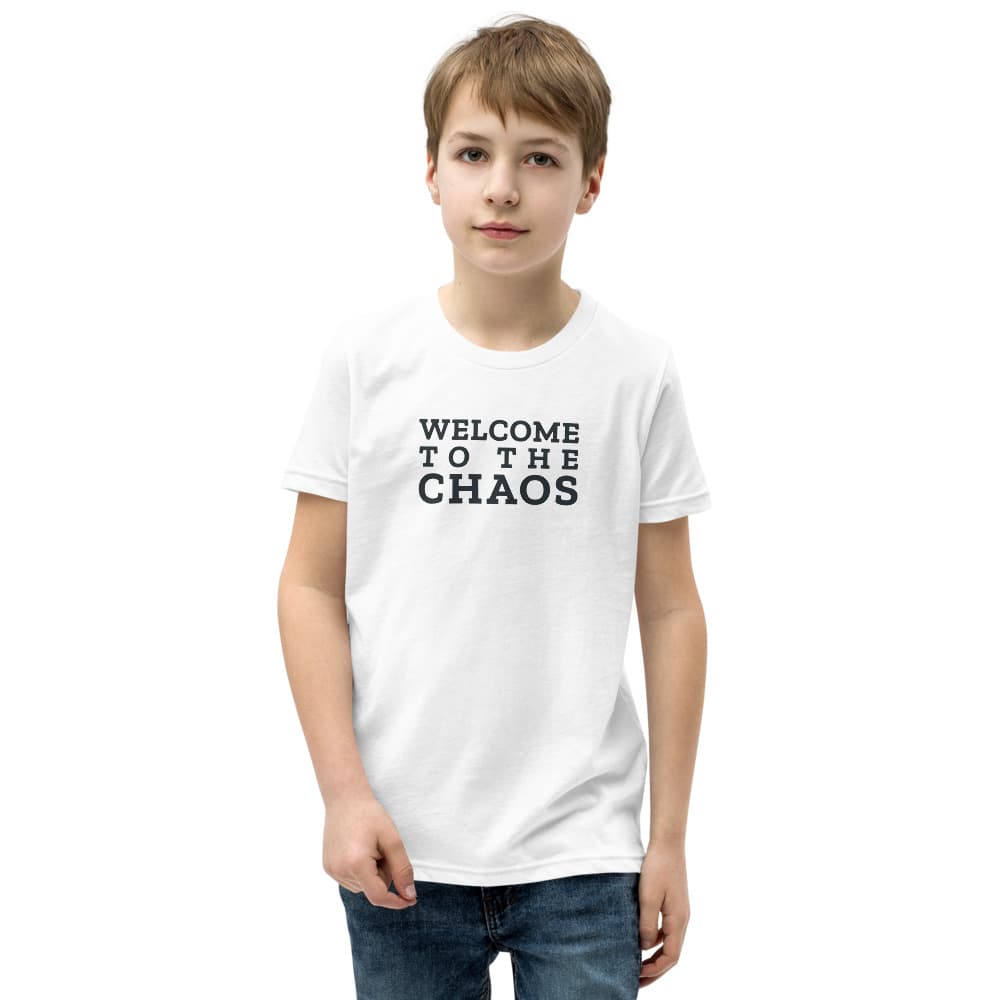 Kids t-shirt with Welcome to the Chaos stacked on the front; the back shows the round Stillwater Mini Ranch barn badge. Shown in White. — Front.