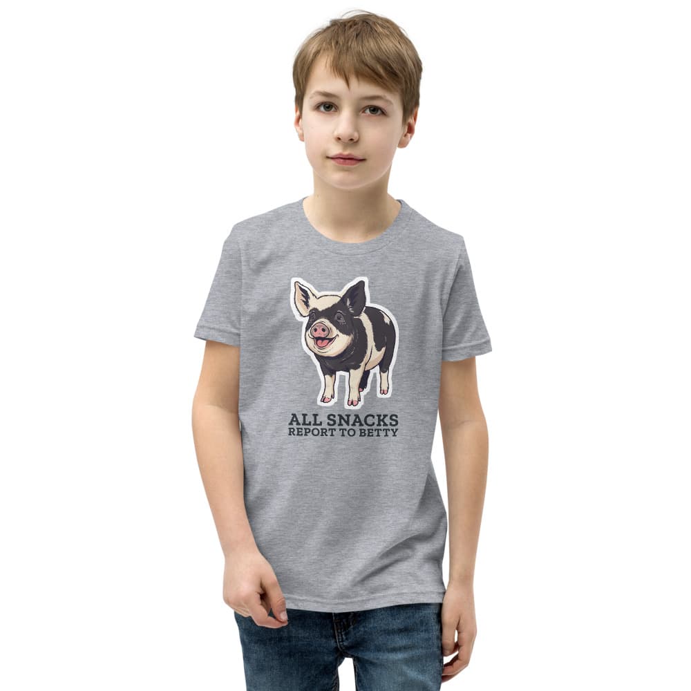 Kids t-shirt with a cartoon of Betty the black-and-cream pig above the words All Snacks Report to Betty. Shown in Athletic Heather.