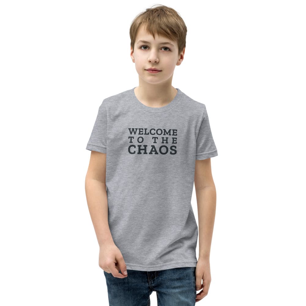 Kids t-shirt with Welcome to the Chaos stacked on the front; the back shows the round Stillwater Mini Ranch barn badge. Shown in Athletic Heather. — Front.