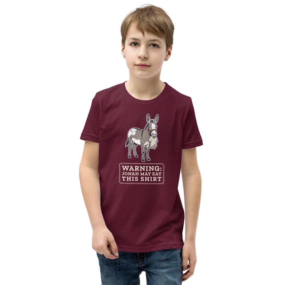 Kids t-shirt printed with a warning that Jonah the donkey may eat this shirt. Shown in Maroon.
